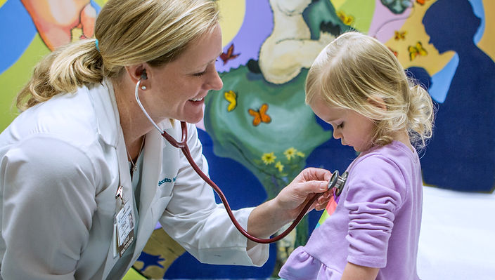 Provider examining a young patient at the clinic