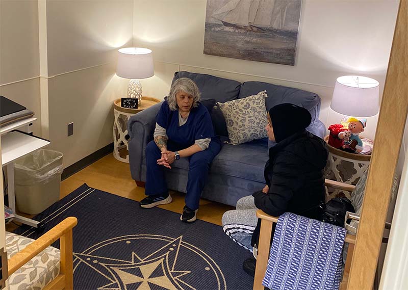 Social services staff assisting a patient