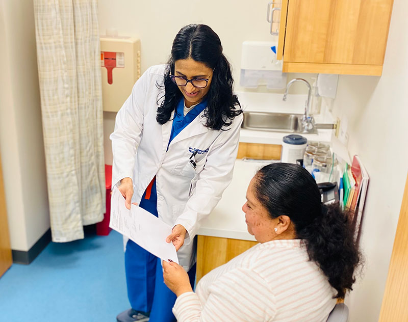 Staff member reviewing eligibility paperwork with a patient